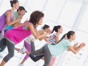 fitness-class-and-instructor-doing-pilates-exercise